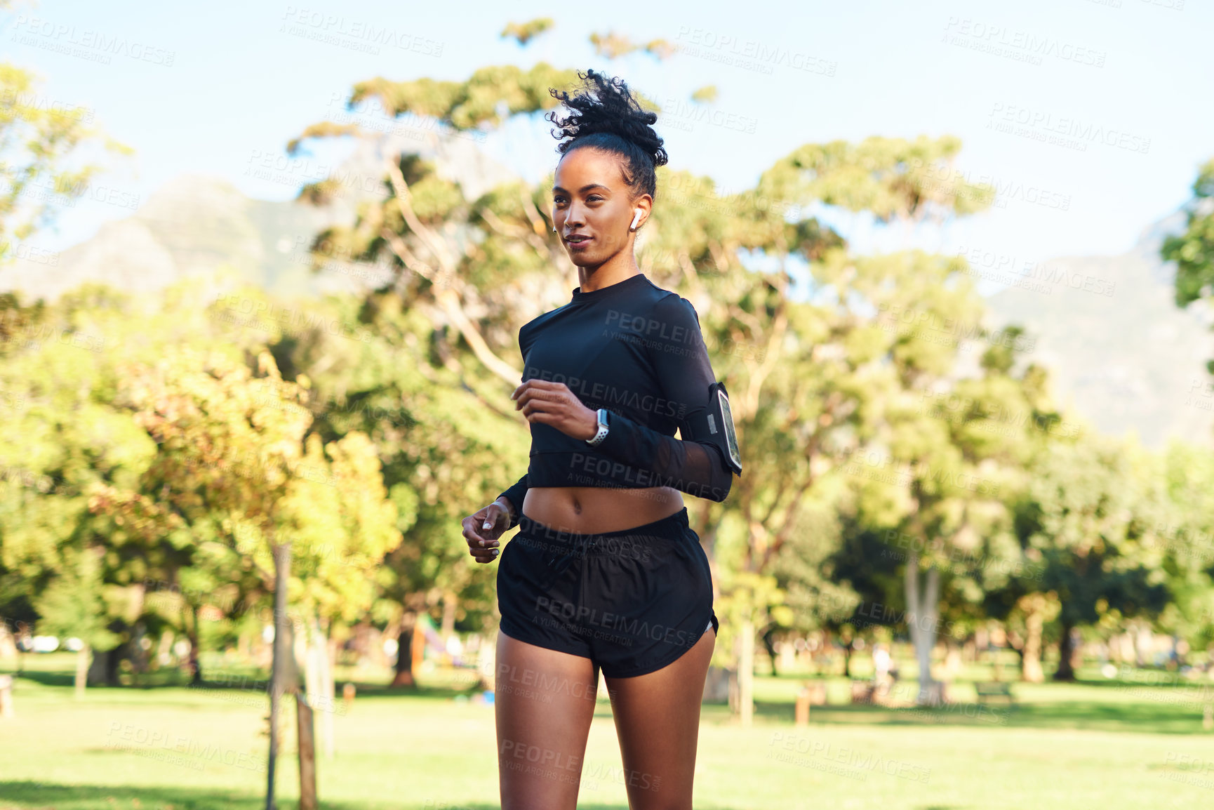 Buy stock photo Cropped shot of an attractive young woman running in the park on her own during the day