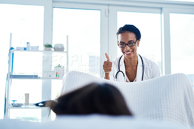 Buy stock photo Shot of a young gynaecologist giving a thumbs up during a consultation with her patient