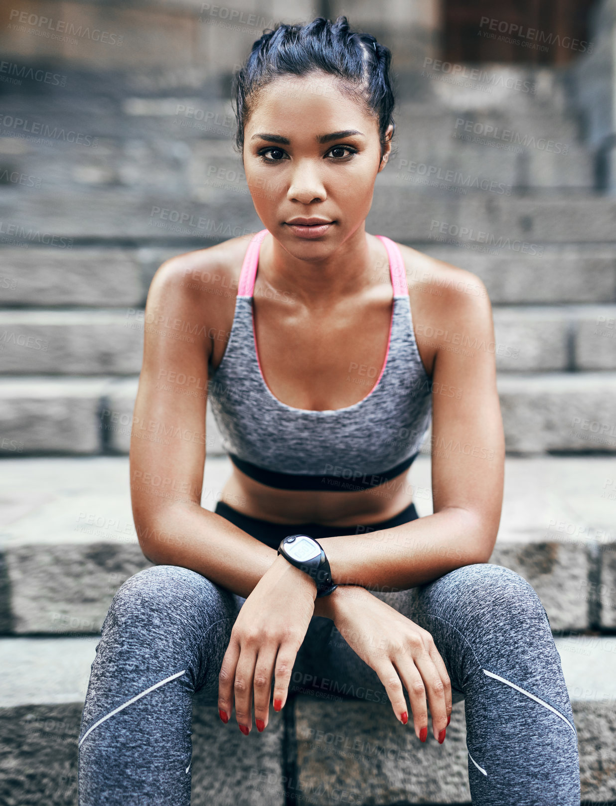 Buy stock photo Portrait of an attractive young sportswoman sitting down on a stairway outdoors in the city