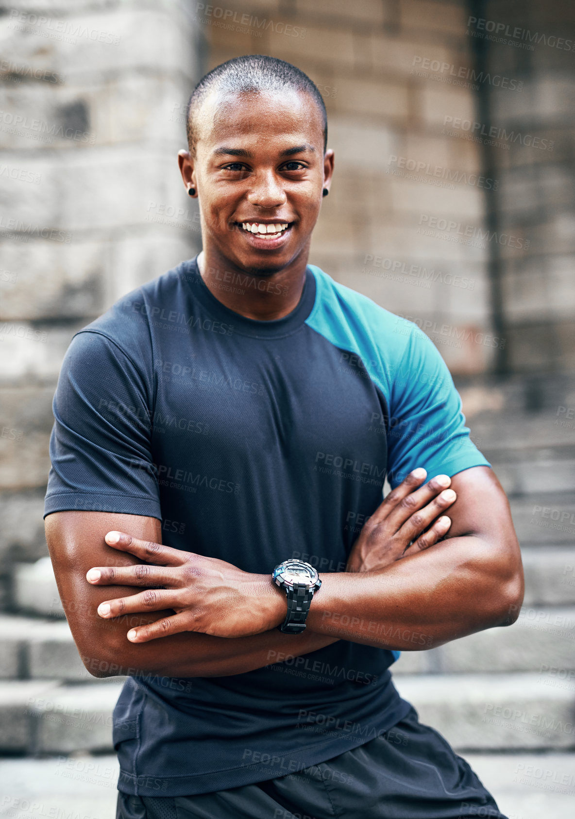 Buy stock photo Portrait of a handsome young sportsman posing with his arms folded outdoors