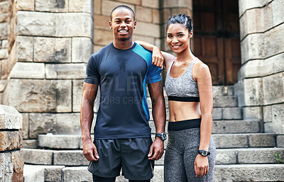 Buy stock photo Portrait of a sporty young couple exercising together outdoors in the city