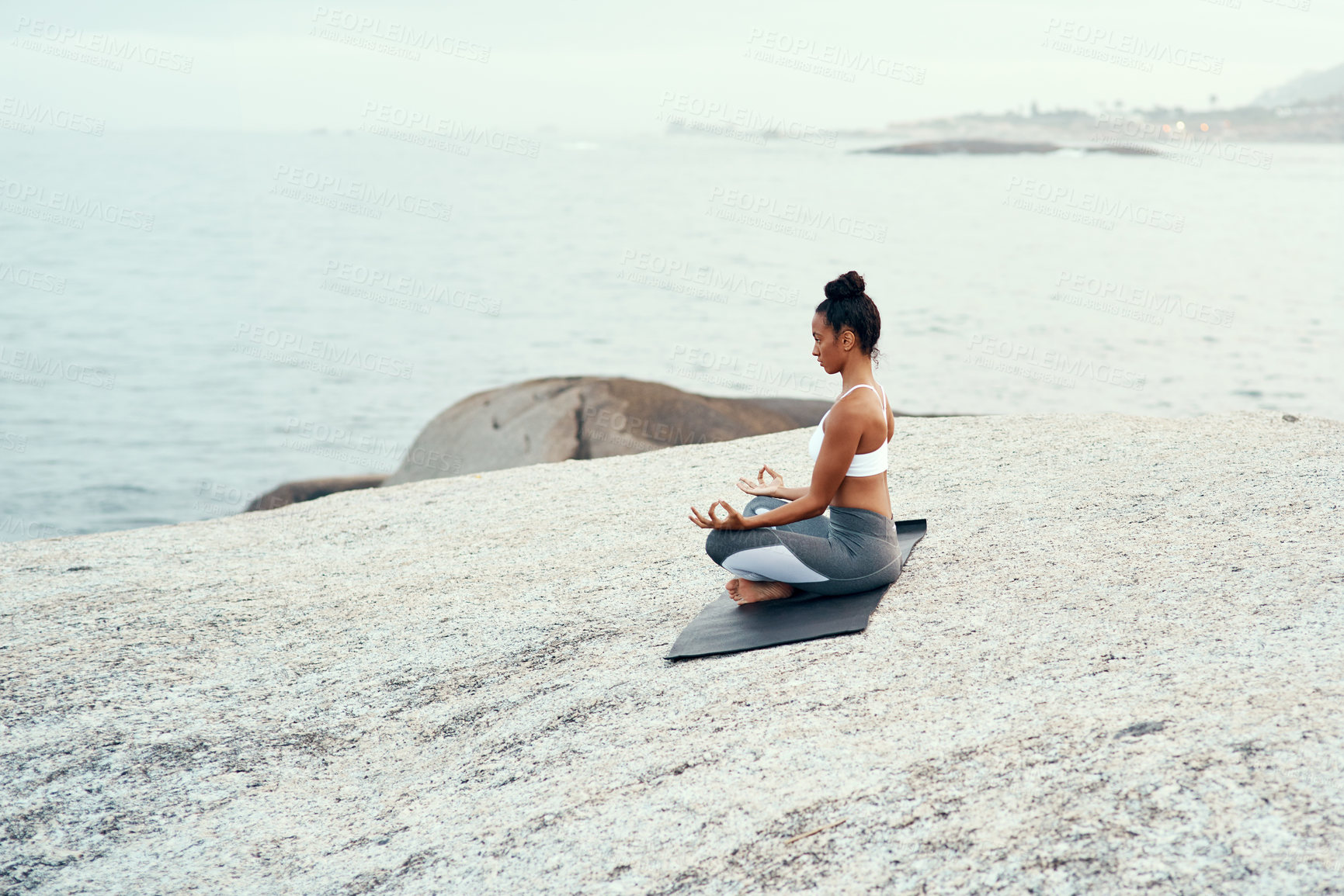 Buy stock photo Yoga, meditation and woman on a beach with lotus pose, wellness and fitness. Pilates, sea and female person on sand with peace in nature feeling relax and calm with spiritual and holistic mockup