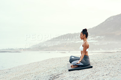Buy stock photo Yoga, outdoor meditation and woman on a beach with lotus pose, wellness and fitness. Pilates, sea and young female person on sand with peace in nature feeling relax and calm with spiritual mockup