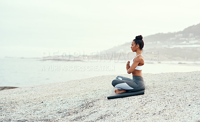 Buy stock photo Yoga, medication and woman on a beach with lotus pose, wellness and fitness. Pilates, sea and female person on sand with peace in nature feeling relax and calm with spiritual and holistic mockup