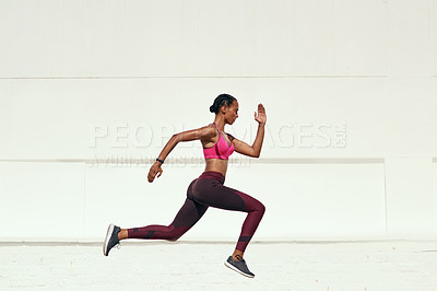 Buy stock photo Shot of a sporty young woman out running