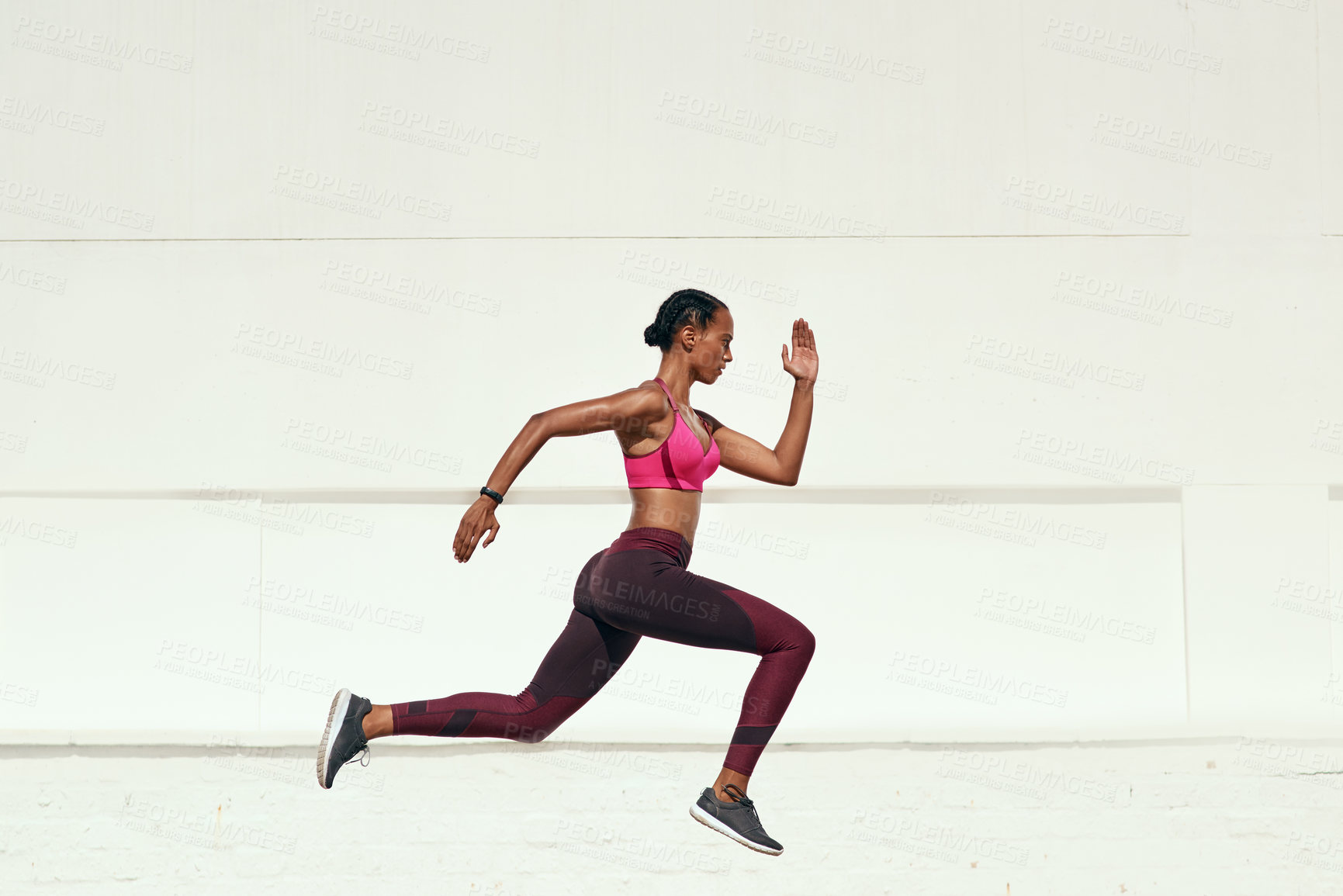 Buy stock photo Shot of a sporty young woman out running