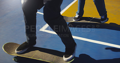 Buy stock photo Shot of two unrecognizable men doing tricks on their skateboards at a skate park