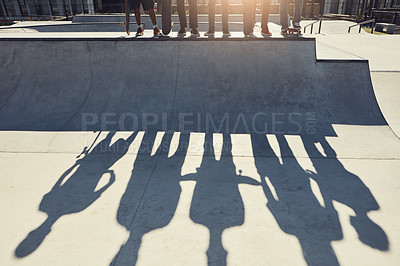 Buy stock photo Shot of an unrecognizable skateboarders standing on a ramp at a skatepark