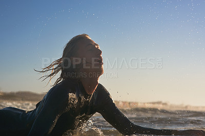 Buy stock photo Shot of a handsome young man surfing in the ocean
