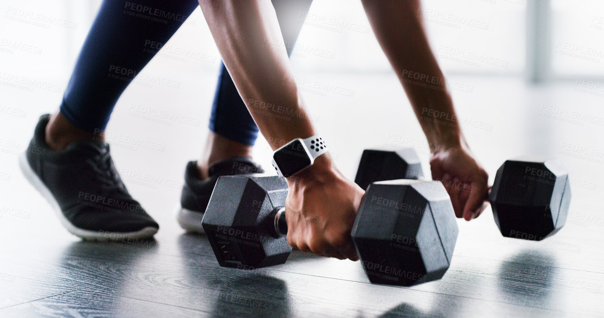 Buy stock photo Cropped shot of a woman working out with dumbbells in a gym