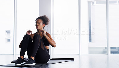 Buy stock photo Shot of a young woman doing sit ups at the gym