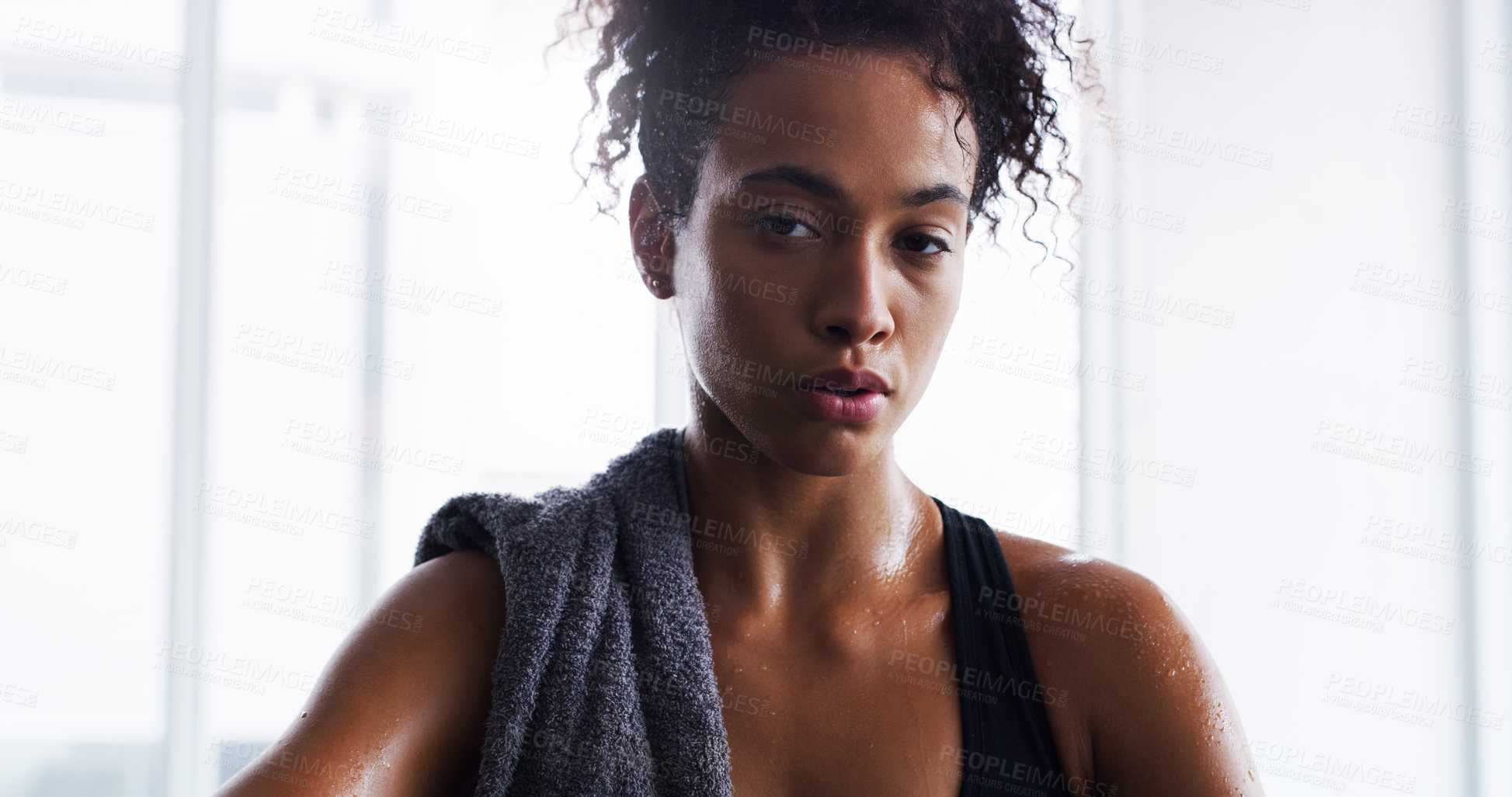 Buy stock photo Shot of a young woman taking a break from her workout in a gym