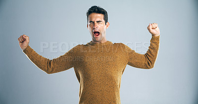 Buy stock photo Studio shot of a handsome young man yawning against a gray background