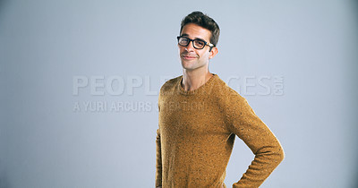 Buy stock photo Studio shot of a confident and handsome young man posing against a gray background