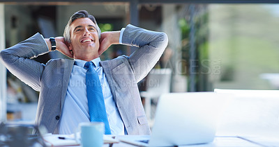 Buy stock photo Cropped shot of a handsome mature businessman looking content while leaning back in a chair with his hands behind his head