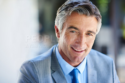 Buy stock photo Cropped portrait of a handsome mature businessman looking confident while working outdoors