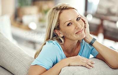 Buy stock photo Cropped portrait of an attractive mature woman relaxing on the sofa at home
