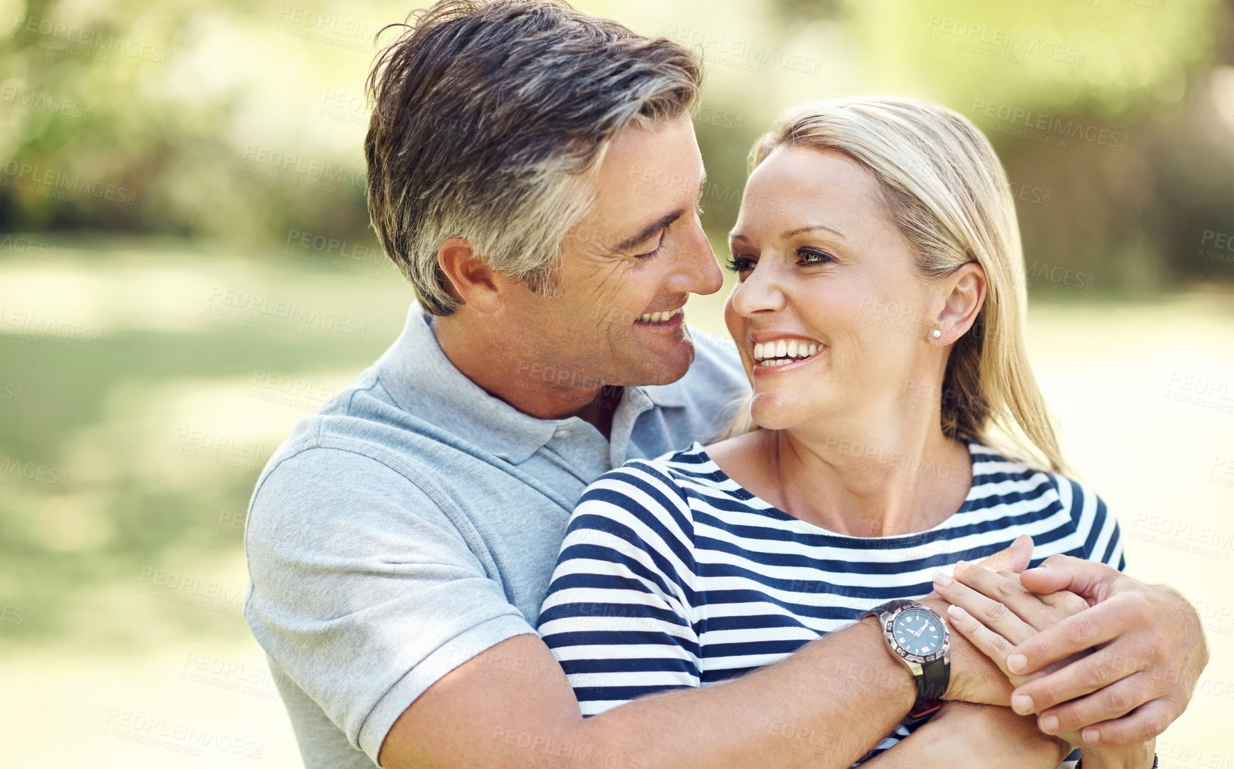 Buy stock photo Love, hug and mature couple in nature at park for bonding, marriage and connection in morning. Outdoor, smile and man and woman embracing in garden for romance on date with happiness together.