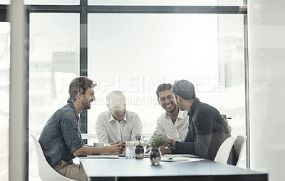 Buy stock photo Cropped shot of a group of businessmen having a meeting around a table in an office