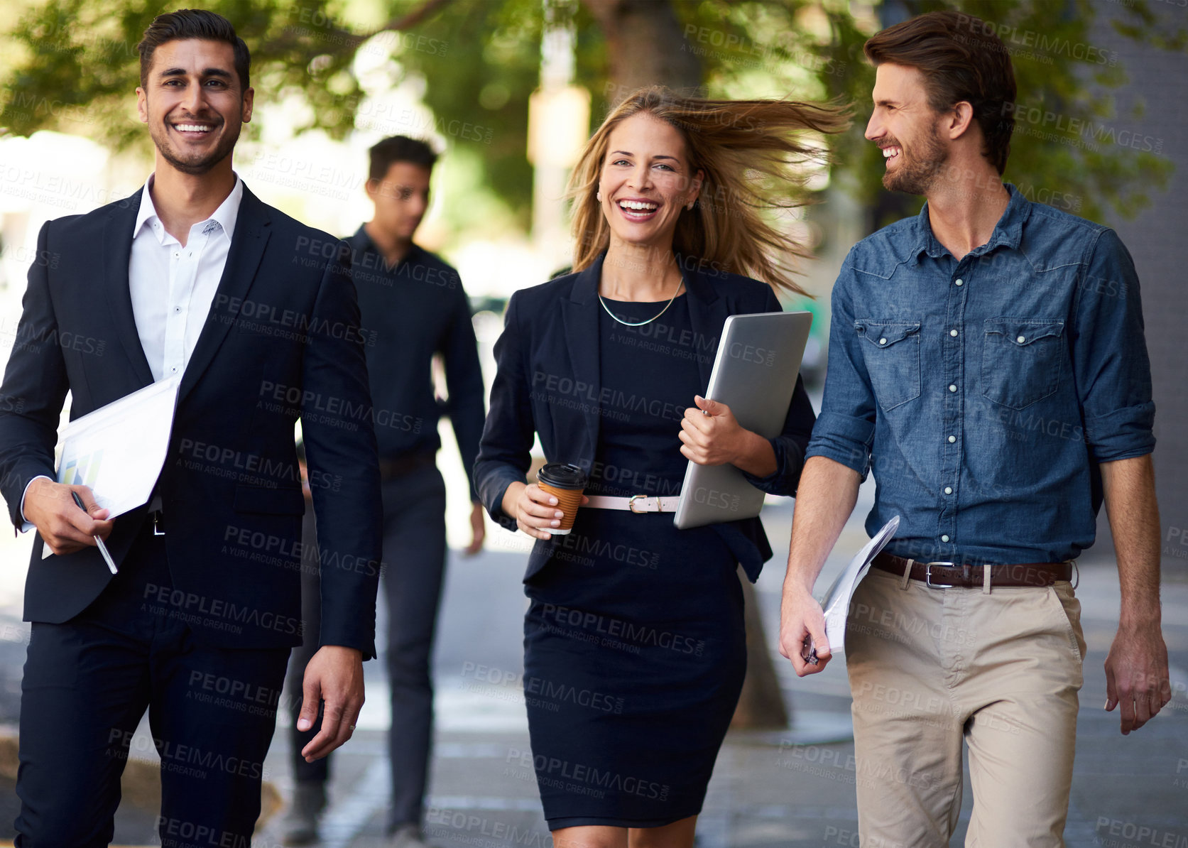 Buy stock photo Cropped shot of a group of corporate colleagues walking down the street on their way to work