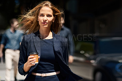Buy stock photo Cropped shot of a confident and stylishly dressed businesswoman walking down the street on her way to work