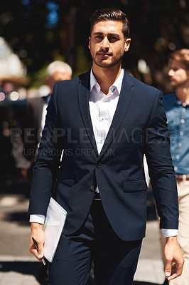 Buy stock photo Cropped shot of a confident and stylishly dressed businessman walking down the street on his way to work