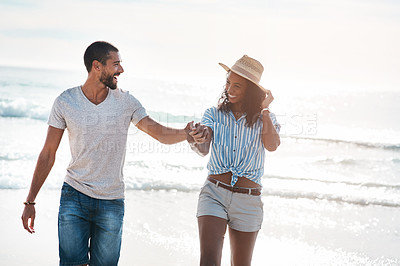 Buy stock photo Couple, smile and holding hands at beach for travel, summer and tropical holiday together in San Diego. Man, woman and walking on sand by ocean for adventure, love and relax on vacation with partner