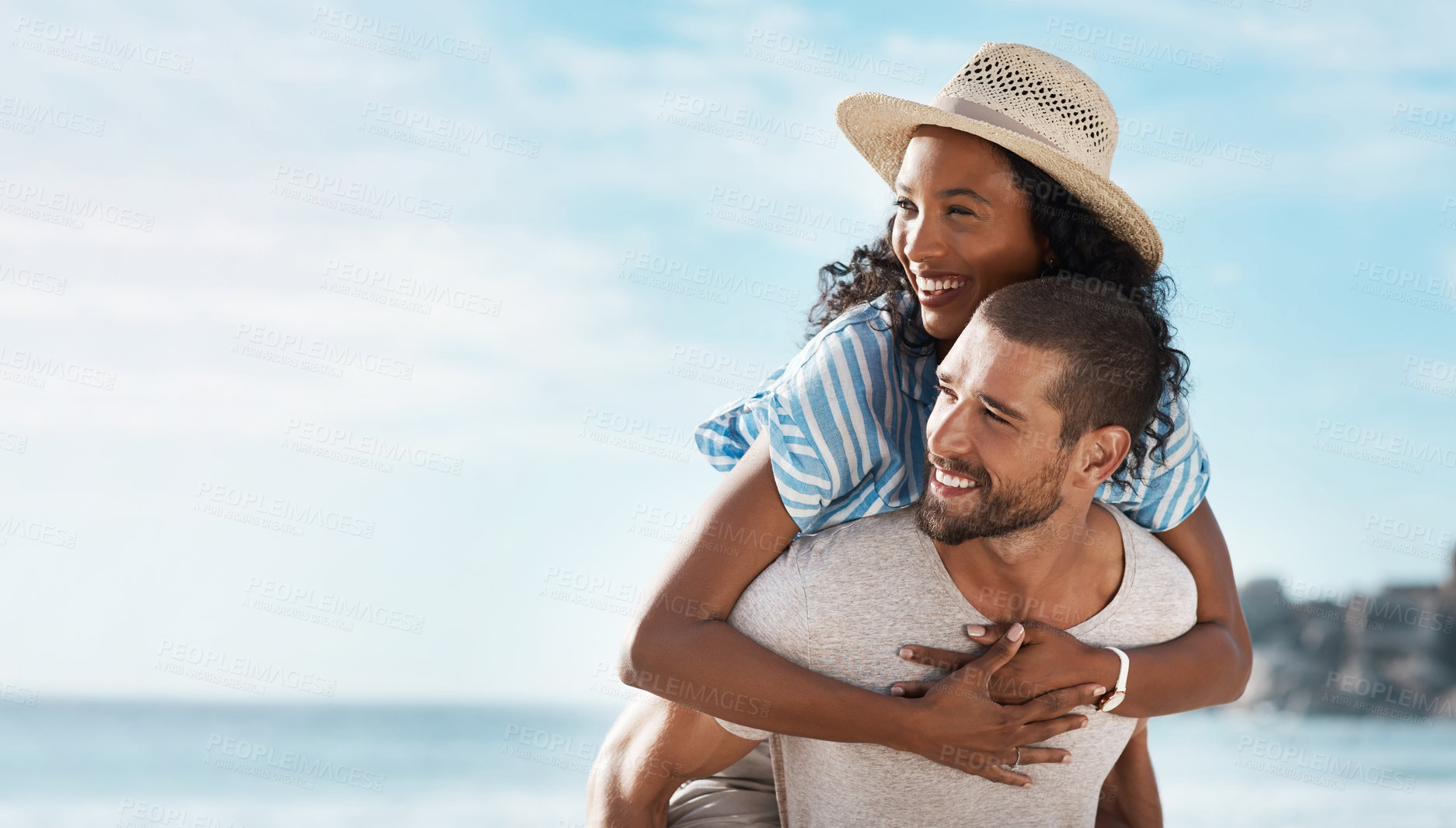 Buy stock photo Love, bonding and piggyback with interracial couple, beach view and relationship for anniversary on holiday together. Romance, man and woman with ocean, summer mockup and space with sunset vacation