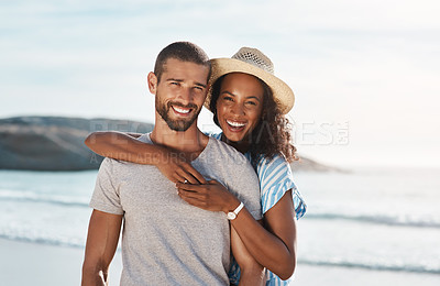 Buy stock photo Portrait of a young couple enjoying some quality time together at the beach