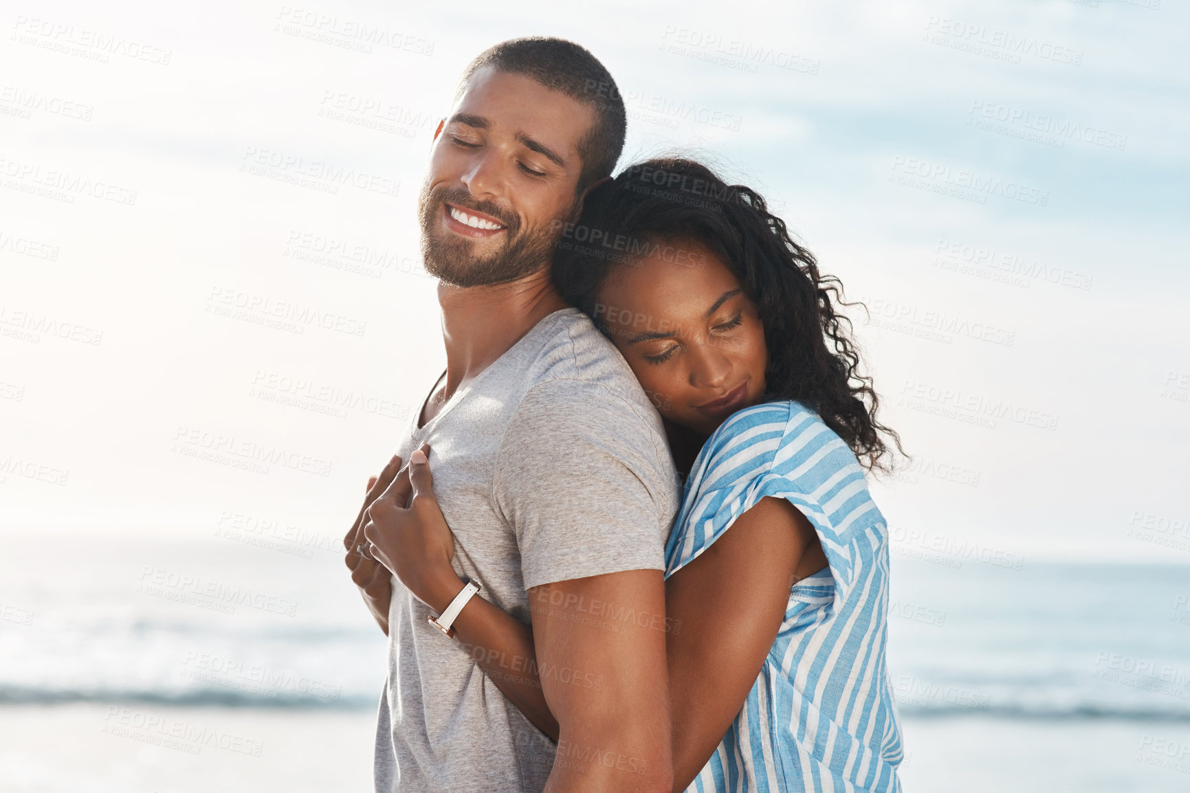 Buy stock photo Love, couple and hug on beach for travel, smile and support in relationship. Man, woman and affection at ocean for summer vacation, holiday and commitment with milestone and engagement in California