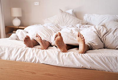 Buy stock photo Sleep, bedroom legs and tired couple relax at home, cozy and peace for morning health, wellness and fatigue. Blanket, feet and exhausted man, woman or people sleeping for comfort in apartment bed