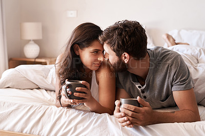 Buy stock photo Home bedroom, coffee and couple bonding, relax and enjoy morning latte, espresso or beverage drinks. Forehead, marriage or romantic man, woman or people with tea cup, love and affection in hotel bed