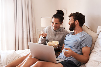 Buy stock photo Laptop, watching movie and popcorn with laughing couple in bed for streaming, relax or internet. Subscription, happy or comic man and woman at home for social media, funny and free time on weekend