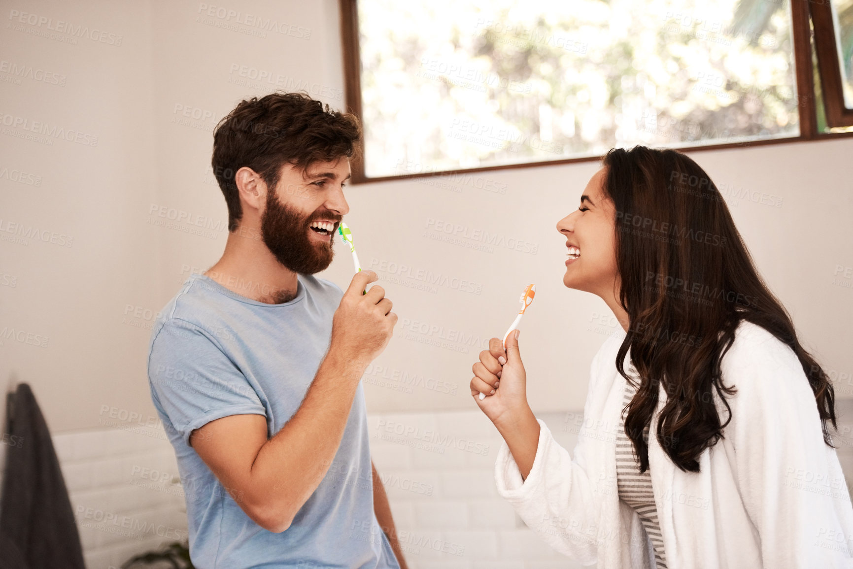 Buy stock photo Brushing teeth, home bathroom and happy couple singing music song with toothbrush, having fun and bonding. Self care, morning singer and people cleaning mouth for health, hygiene or dental wellness