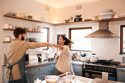 Buy stock photo Excited young couple, dance and kitchen in home with love, comic moment and cooking together with romance. Man, woman and smile with dancing, moving and happiness for food, nutrition or diet in house