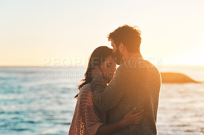 Buy stock photo Sunset, beach and couple kiss forehead for relax, bonding and quality time on romantic date. Nature, travel and man and woman embrace for anniversary or honeymoon on holiday, weekend and vacation