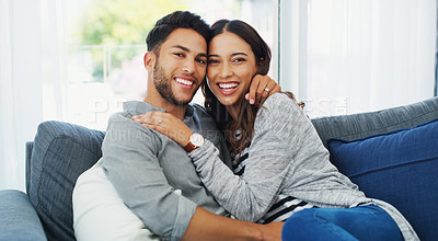 Buy stock photo Cropped portrait of an affectionate young couple holding each other while in their living room during the day
