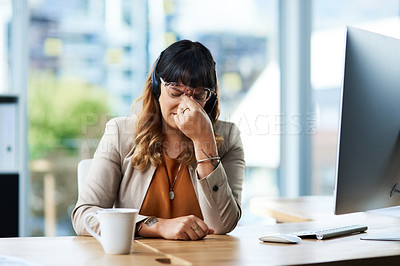 Buy stock photo Cropped shot of an attractive young businesswoman suffering from a headache while in her office during the day