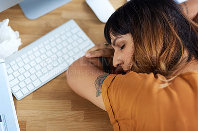 Buy stock photo Cropped shot of an attractive young businesswoman asleep at her desk while at work during the day