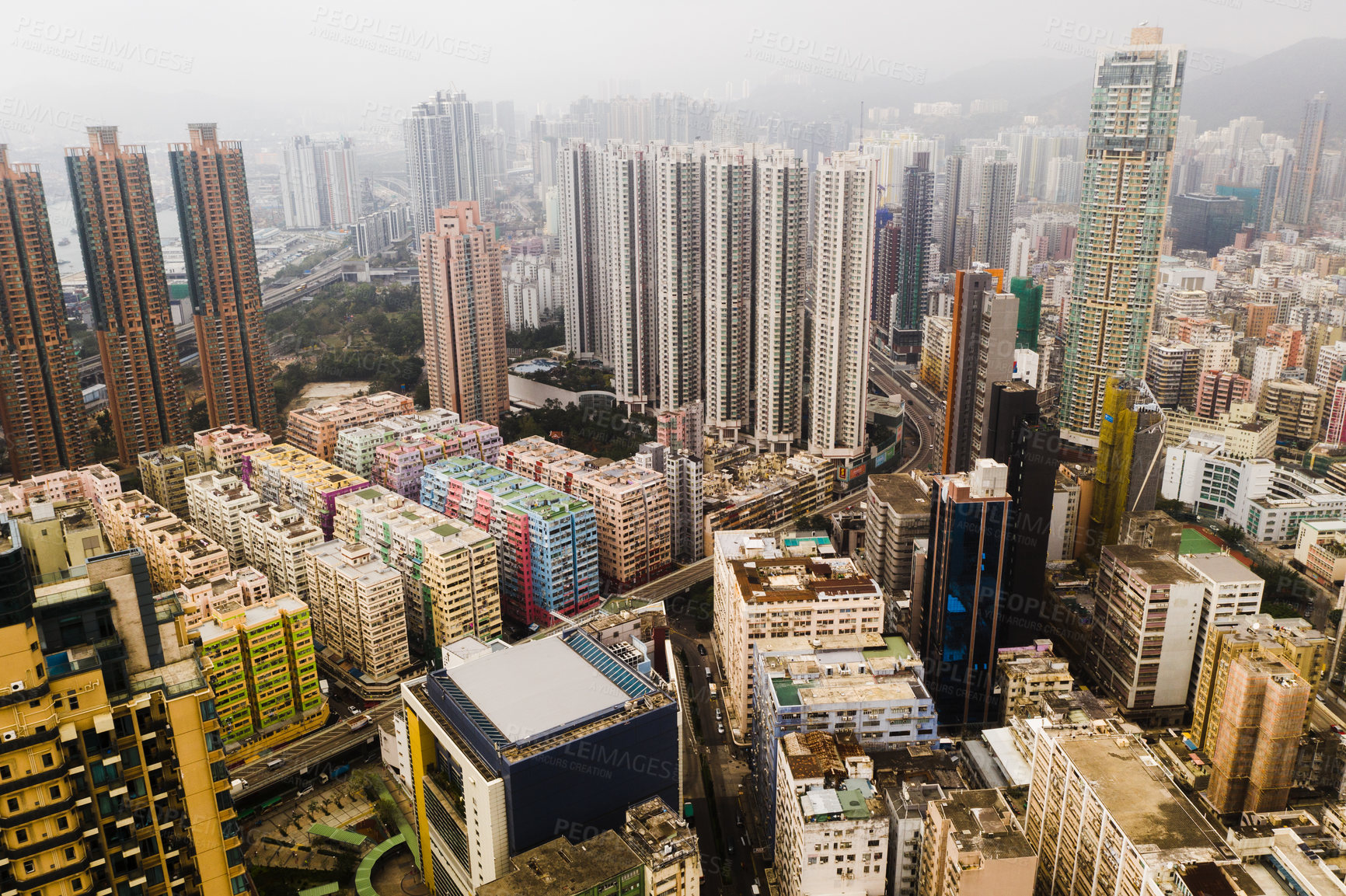 Buy stock photo Architecture, skyscraper cityscape and aerial view of buildings in Hong Kong with fog. Urban landscape, city building skyline and drone shot of skyscrapers and property in central business district.