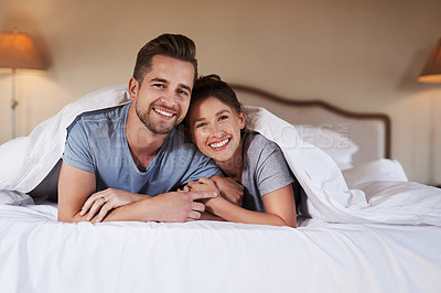Buy stock photo Portrait of an affectionate young couple spending some quality time together in their bedroom at home
