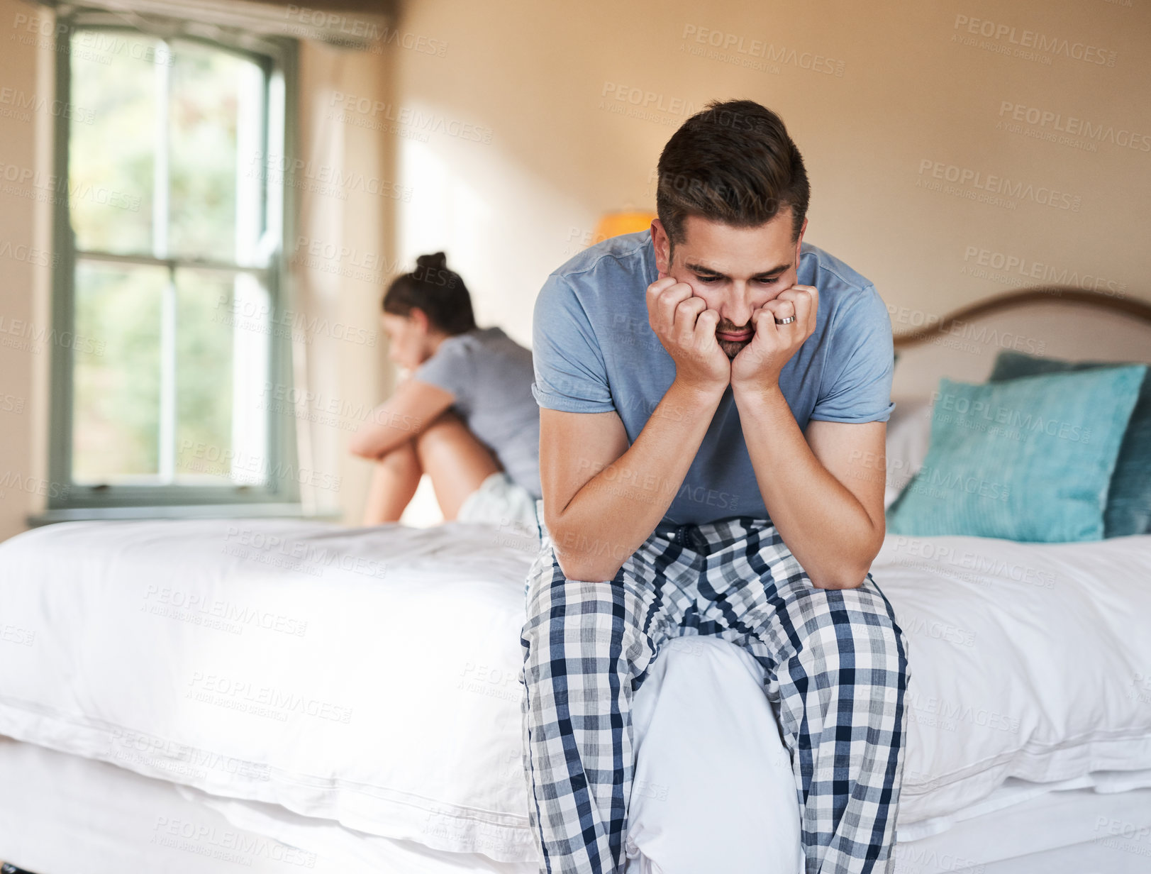 Buy stock photo Shot of a young couple having an argument in their bedroom at home