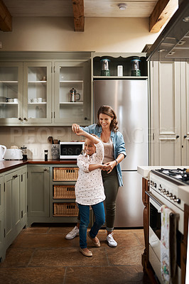 Buy stock photo Shot of a young girl dancing at home with her mother