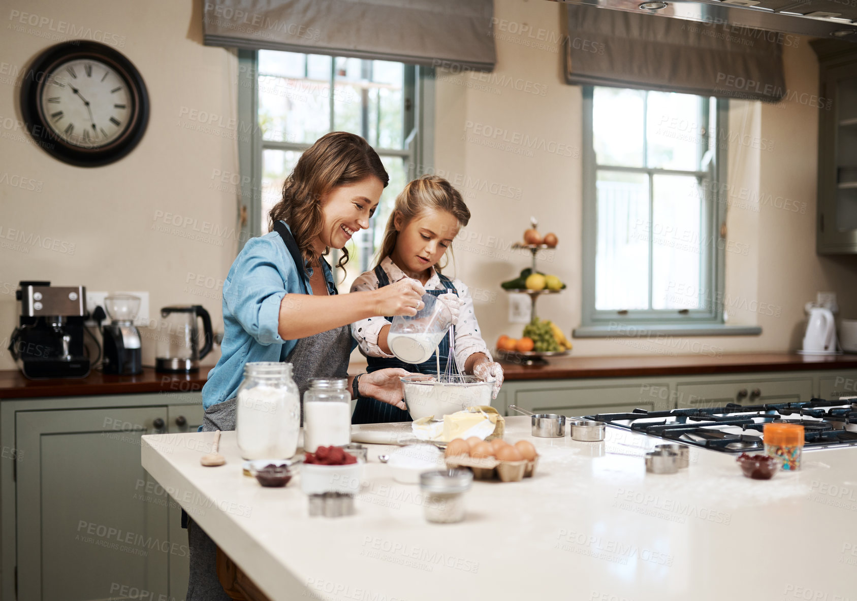 Buy stock photo Baking, mama and girl in kitchen, ingredients and recipe with utensils, hobby and time together. Family, single parent and teaching with mother, daughter and happiness with cooking, home or learning