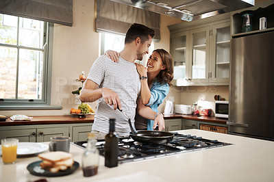 Buy stock photo Love, food and cooking with couple in kitchen and hugging for breakfast, morning and happiness. Smile, care and nutrition with man and woman eating at home for happy, health and hungry together