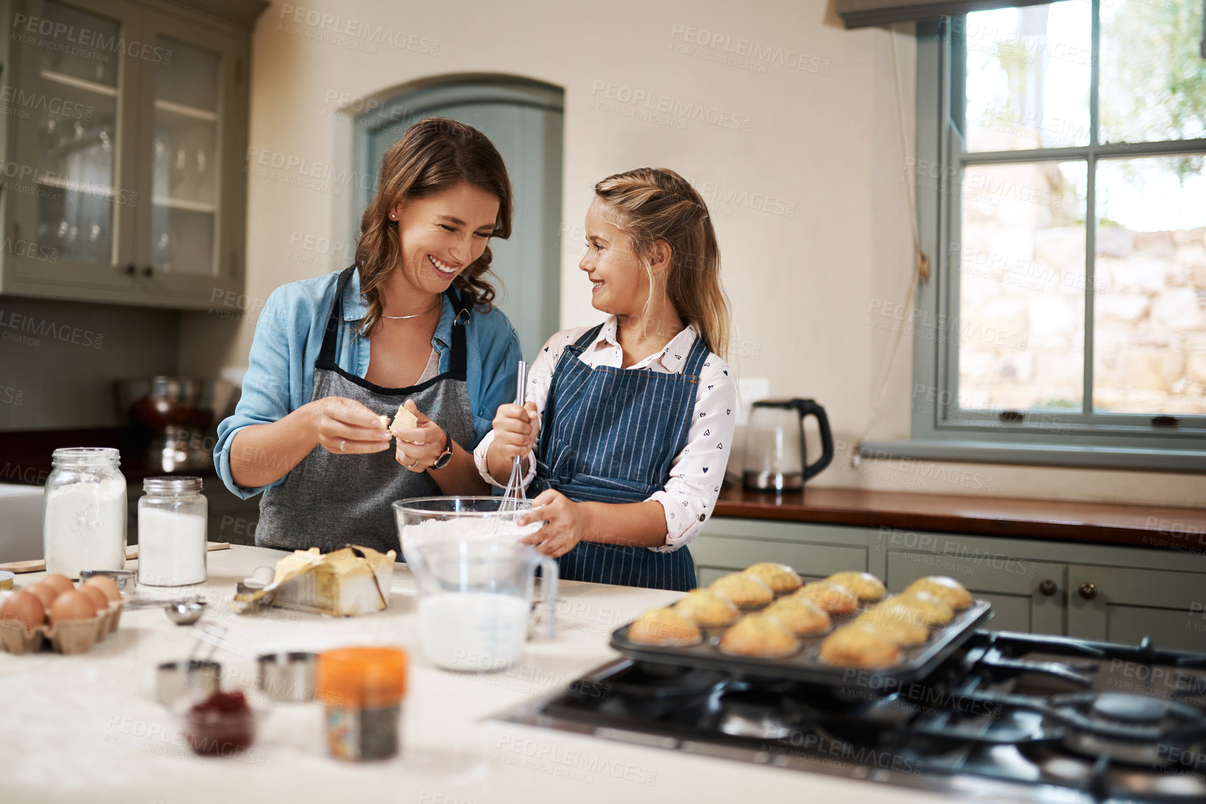 Buy stock photo Baking, mama and girl in kitchen, teaching and ingredients with time together, muffins and child development. Parent, mother or daughter with nutrition, learning and home with support or utensils