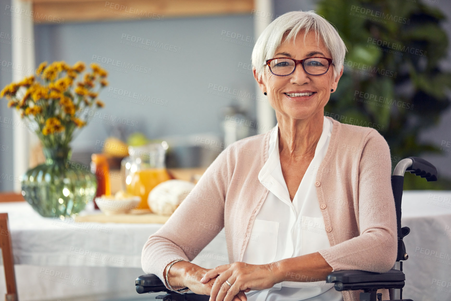 Buy stock photo Cropped portrait of a happy senior woman smiling while sitting in her wheelchair in a retirement home