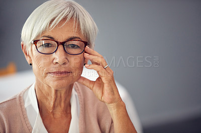 Buy stock photo Cropped portrait of a confident senior woman sitting alone inside a retirement home