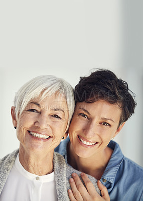 Buy stock photo Cropped portrait of an affectionate young woman embracing her aged mother at home
