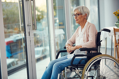 Buy stock photo Cropped shot of a senior woman looking thoughtful while sitting in her wheelchair at a retirement home